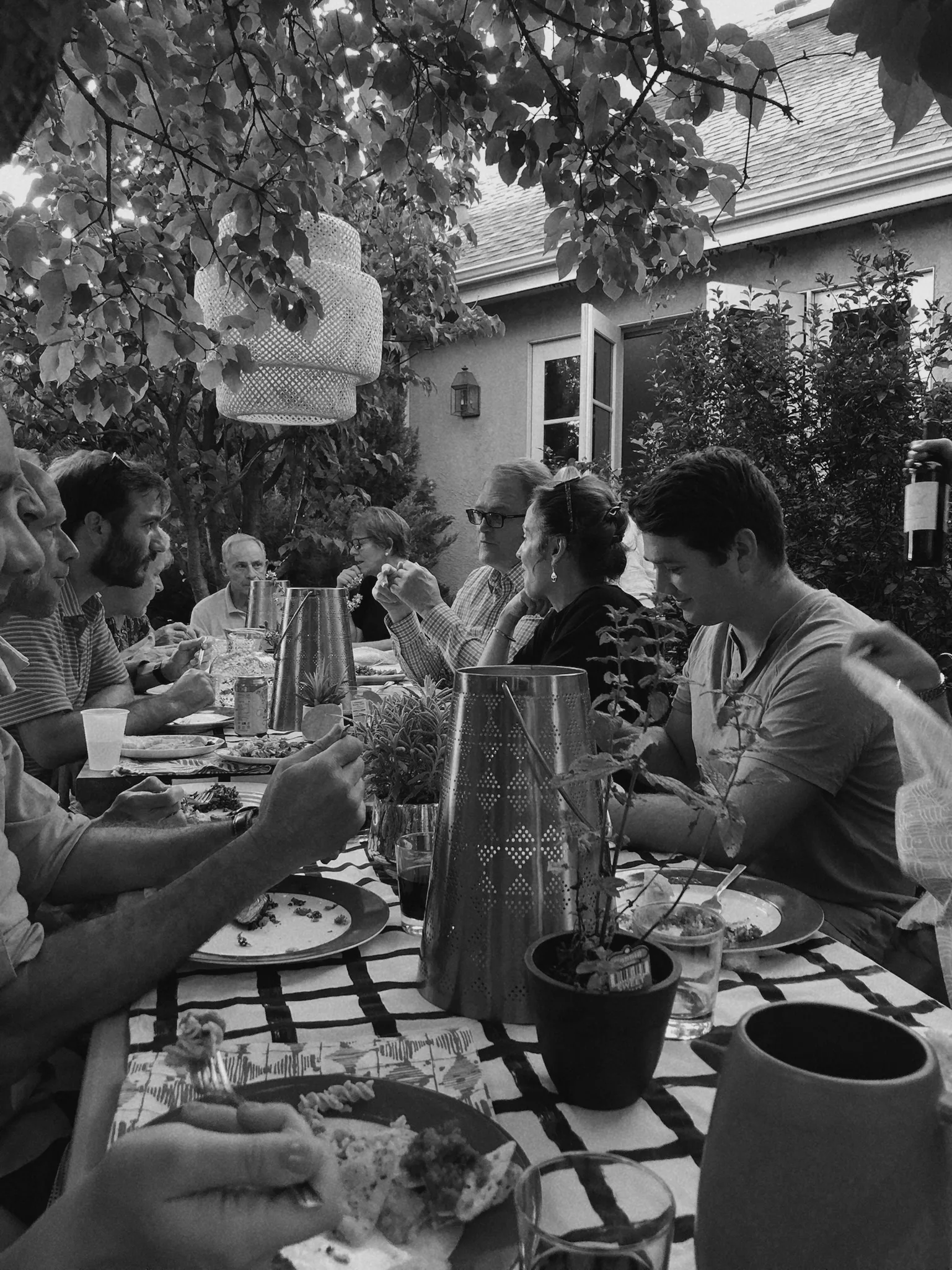 Backyard dinner party with gold lanterns