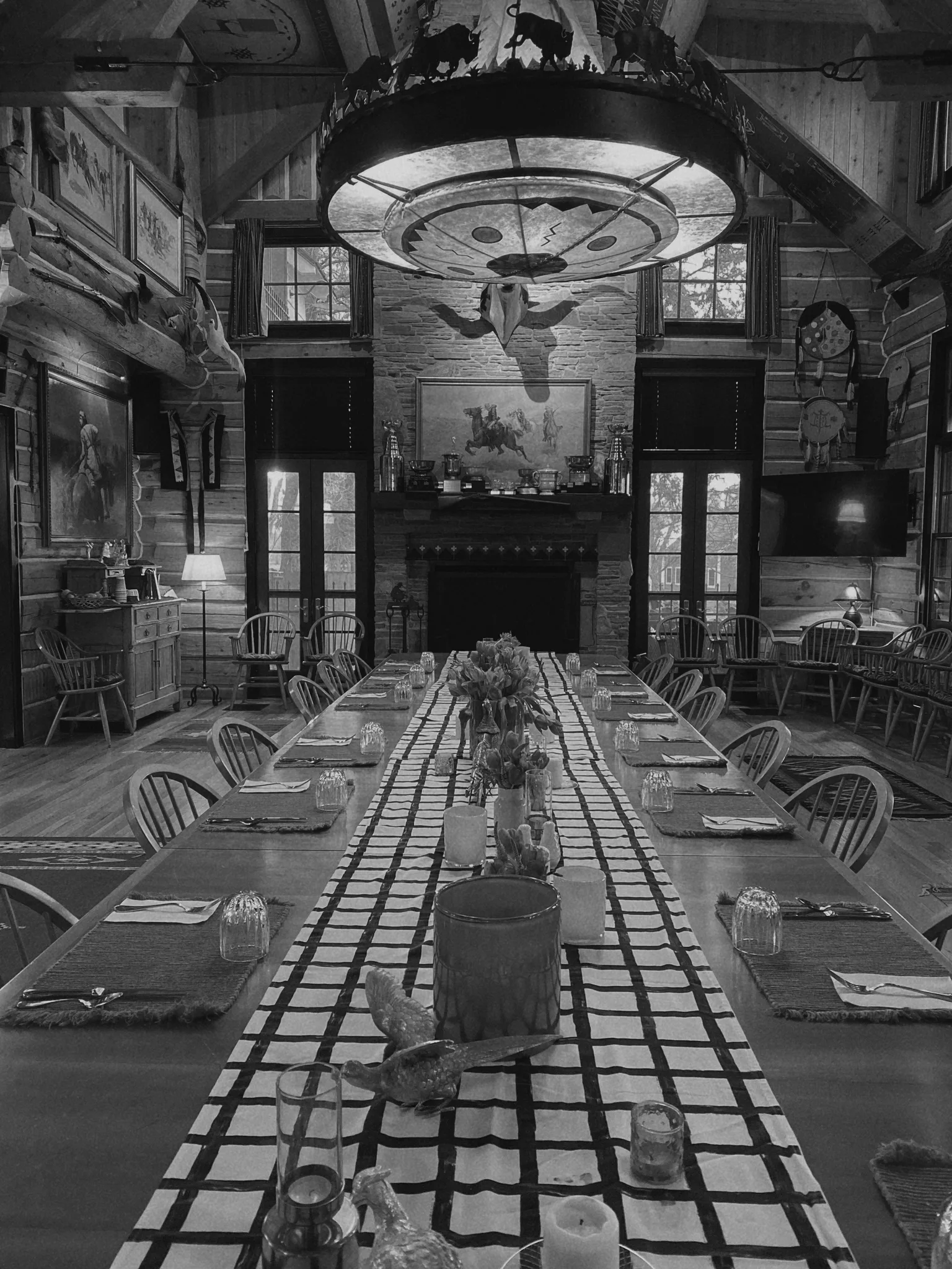Rustic lodge dining room with long table set for dinner