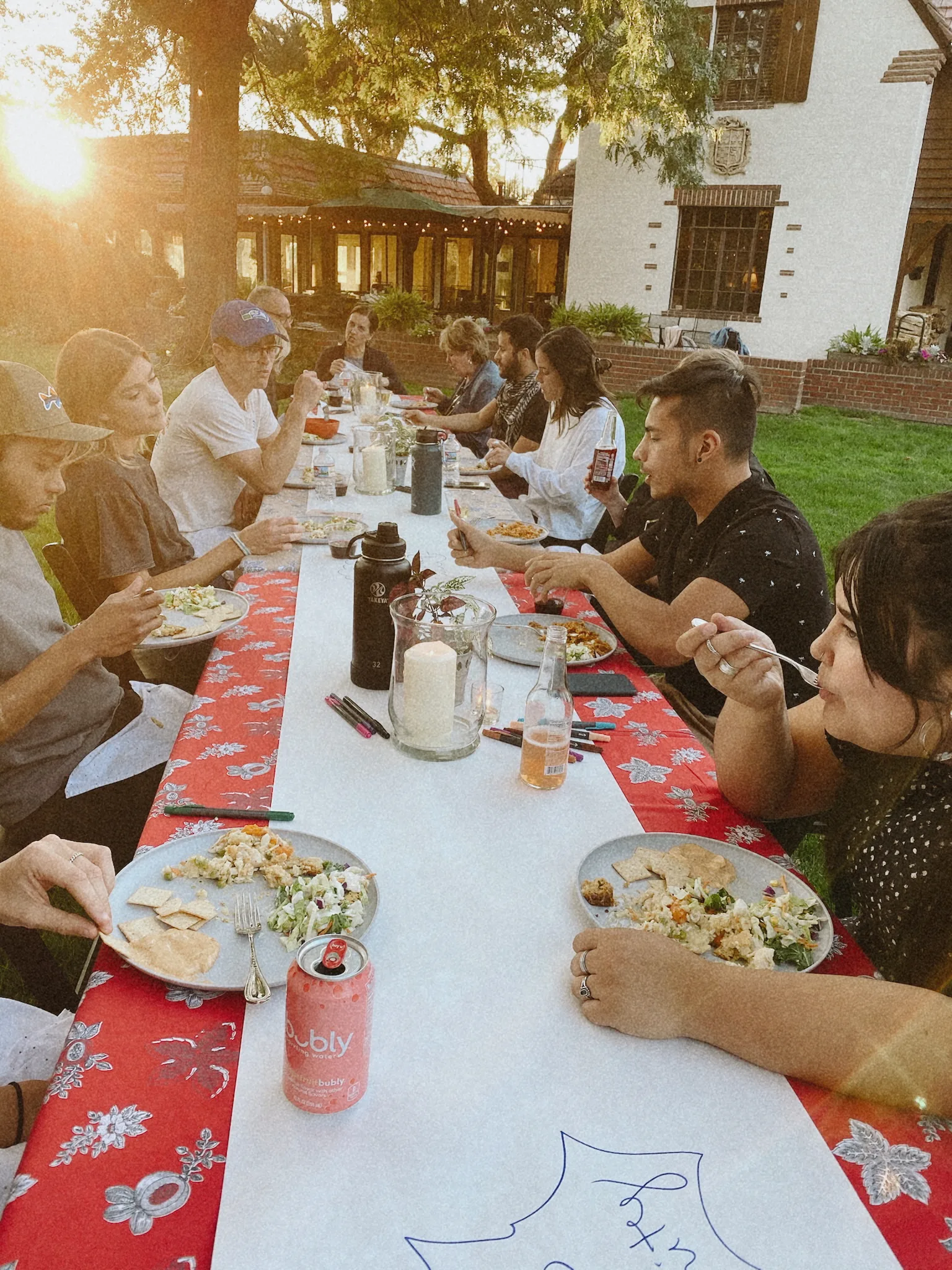 Backyard sunset dinner at long table
