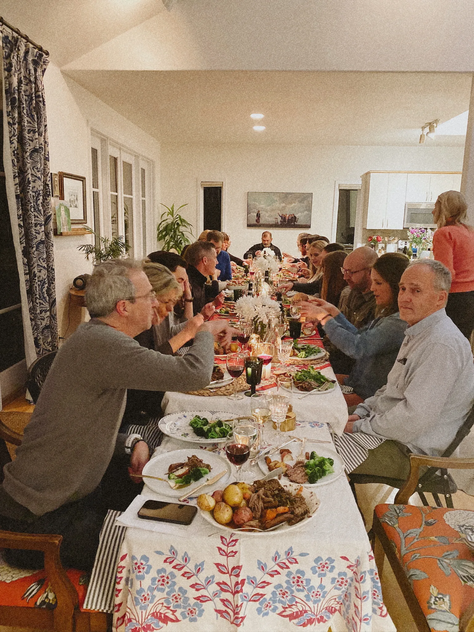 Indoor dinner party guests toasting