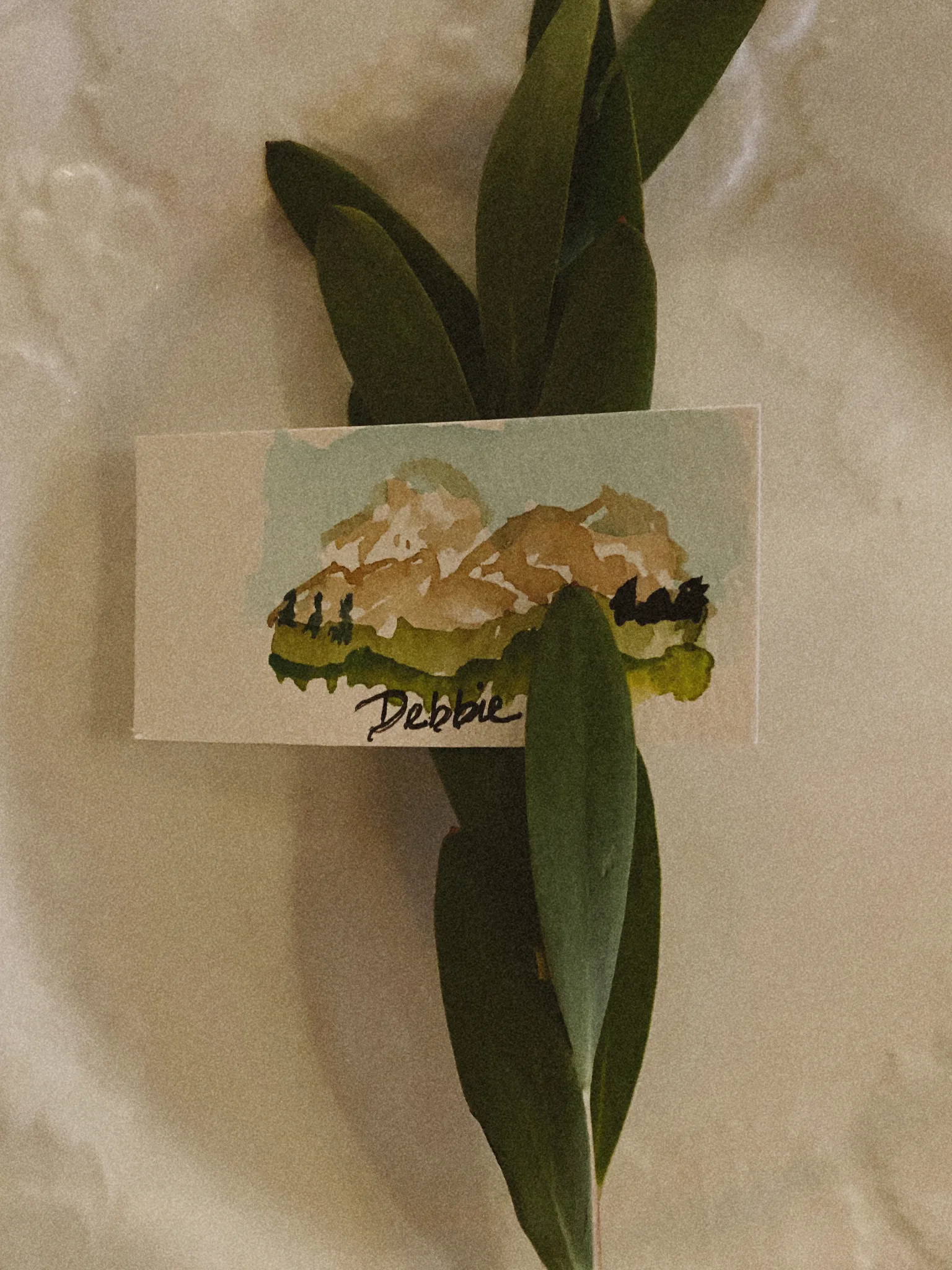 Painted watercolor place card with greenery